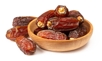 dried date palms in the wooden bowl, isolated on white background