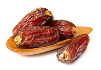 dried date palms in the wooden spoon, isolated on white background