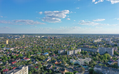 Fototapeta premium urban landscape against the blue sky and many trees