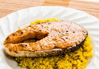 Salmon steak with yellow rice in plate, in door  Chiangmai  Thailand