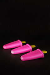 pink form for making ice cream on a black background