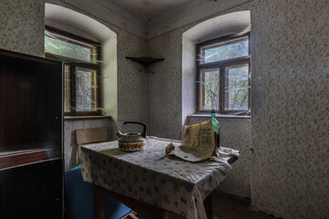table with a teapot and newspaper