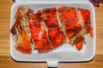 Roasted duck in a foam container