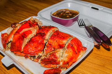Roasted duck in a foam container