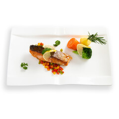 Grilled salmon with vegetables served on white plate on white background.