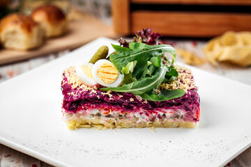 Russian dish Herring under a fur coat with greens 