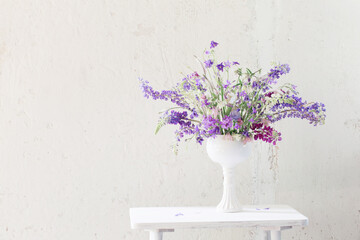 summer bouquet in blue and violet colors on white background