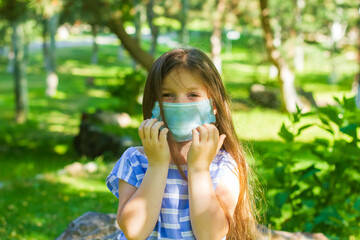 little girl with mask, pretty girl with medical mask in park