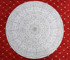 Hand-drawn lotus mandala on gray paper on red background