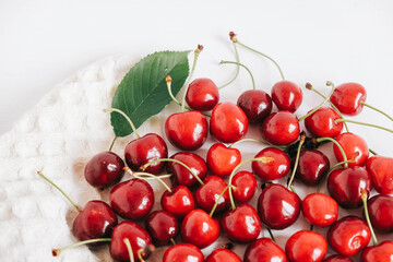 Fresh ripe cherry on the white wooden background. Top view. Copy, empty space for text