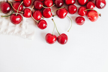 Obraz na płótnie Canvas Fresh ripe cherry on the white wooden background. Top view. Copy, empty space for text