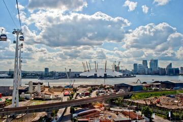Emirates Air Line cable car travels over the Thames and The O2 Arena Greenwich London Docklands