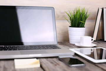Fototapeta premium Tablet and PC on wooden table