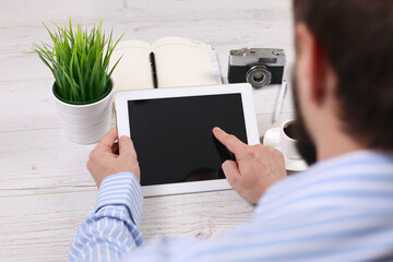 Businessman holding digital tablet with blank screen in coffee shop cafe