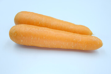 Two fresh whole carrots on white background, healthy ingredient with beta-carotene and vitamin for eating
