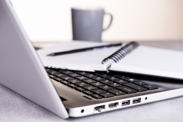 Workplace, notebook with notebook and pencil and cup of coffee close up