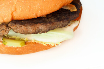 Piece of homemade burger isolated on white background, top view