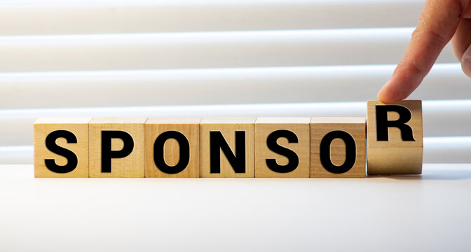 Close Up Hand Of A Businessman Arranging Small Wooden Blocks On The Table For Business Sponsor And Scholarship Concept.