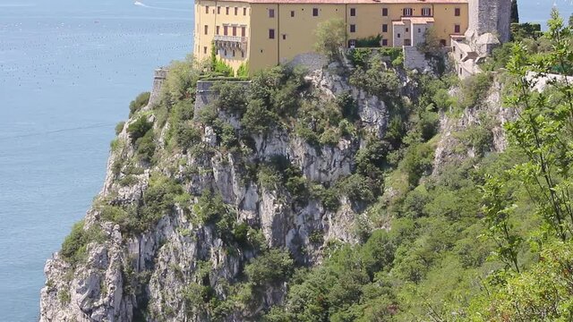 Beautiful Duino castle on the rocky coast near Trieste, Italy, with its famous tiny beach at the base of the cliff