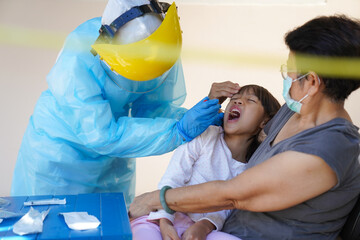 The doctors in the PPE protective suit performed a nasal congestion swab covid from a person to...