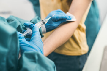 Close up woman doctor doing syringe vaccine in hospital for preventing a stop corona virus outbreak - Healthcare medicine and medical cure against pandemic concept