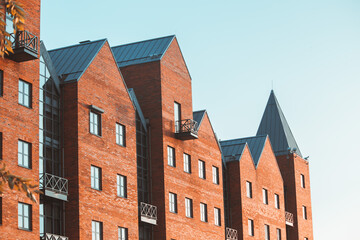 Brick new building with a sharp roof in the city of Dnipro.
