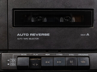 Close up front a deck recorder of the vintage stereo cassette tape player with the push operation buttons are retro technology