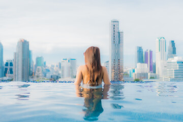 Portrait beautiful young asian woman relax happy smile leisure around outdoor swimming pool