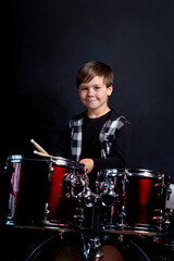 Beautiful brunette boy is rehearsing before a performance. Blue background.