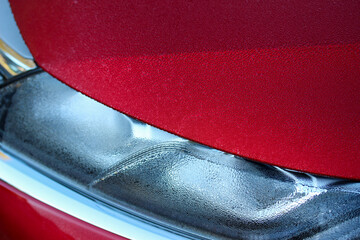 Red car on a cold winter morning