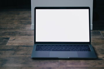 laptop on a wooden background top view, white screen and space for text. Modern laptop