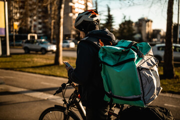 Fototapeta na wymiar Delivery boy on bicycle in city