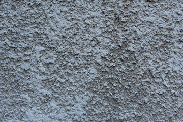 Close-up - gray-brown stone wall in the old facade of the house