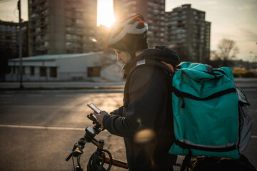 Delivery boy on bicycle in city