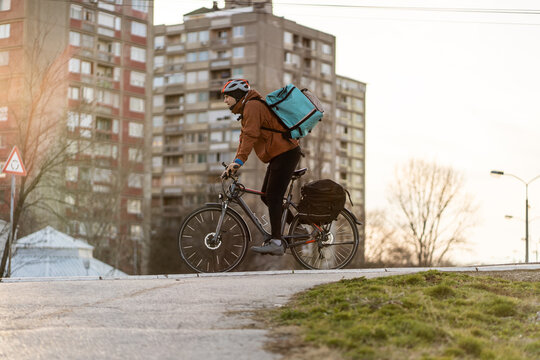 Young man working as bike courier in the city