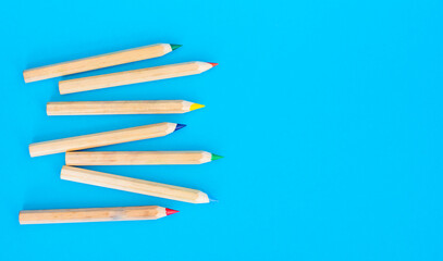 color wooden pencils on a blue background. natural color. Art and hobby tools, a set of colorful stationery