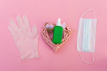 pills, nitrile gloves with a surgical mask on a pink background