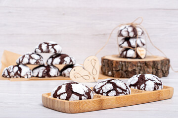 Marble chocolate cookies on a wooden stand in powder
