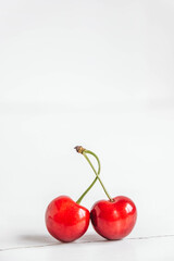 Fresh ripe cherries on the white wooden background. Copy, empty space for text