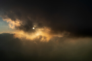 Cloudy sky against the sun over Maritime Alps mountain range, South France