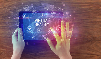 Close-up of a tablet with VIRTUAL REALITY inscription, innovative technology concept