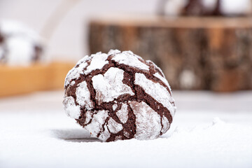 Marble chocolate cookies on a wooden stand in powder