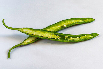 Cut green chili on a nice white backgound,  Selective focus, Selective focus on subject, background blur .