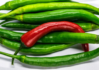 a bunch of green and red chillies in white background, Selective focus, Selective focus on subject, background blur