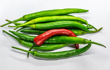 a bunch of green and red chillies in white background, Selective focus, Selective focus on subject, background blur