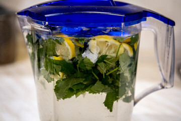 Cold summer drink lemonade in a clear plastic jar in my kitchen