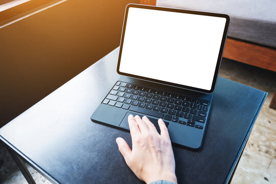 Mockup image of a woman using and touching on tablet touchpad with blank white desktop screen as a computer pc