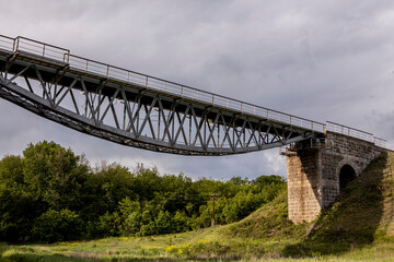Fototapeta na wymiar The beautiful high railway bridge. Metal construction