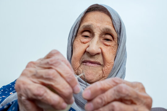 Arabic Muslim Old Woman Inserting Thread In Needle