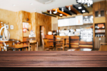 Empty wooden desk space and blurry background of restaurant vintage tone for product display montage